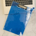 A4 transparent polypropylene clipboard with metal clip, shown in blue, holding paper.