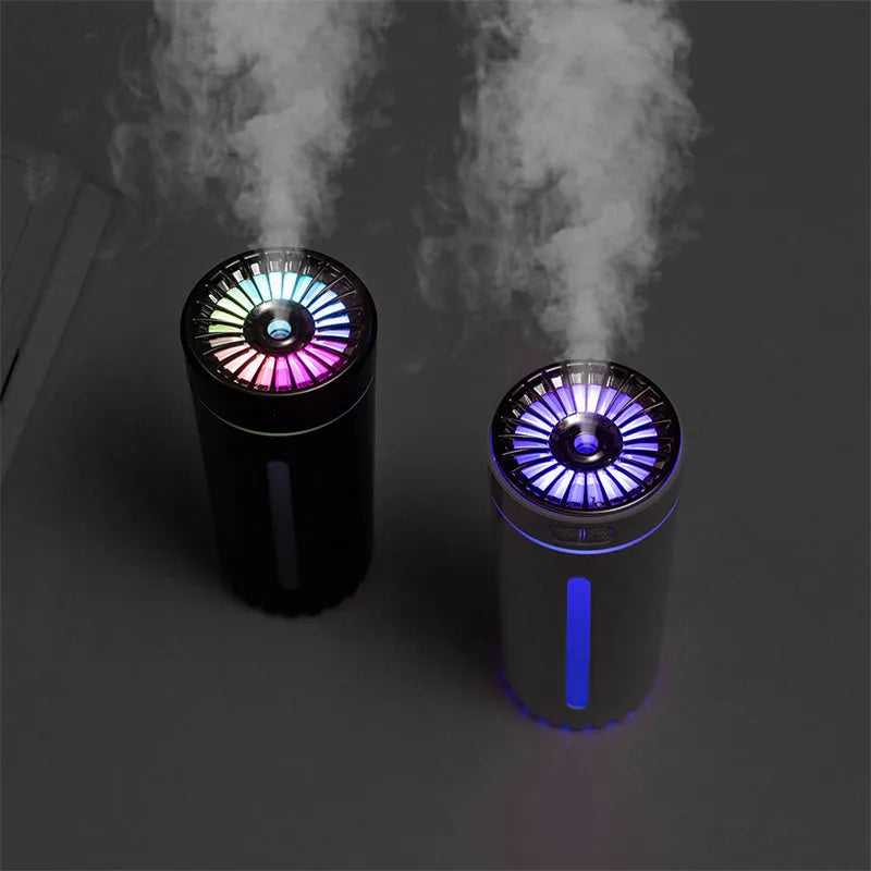 Black portable ultrasonic humidifier with colourful LED lights on a car cup holder.