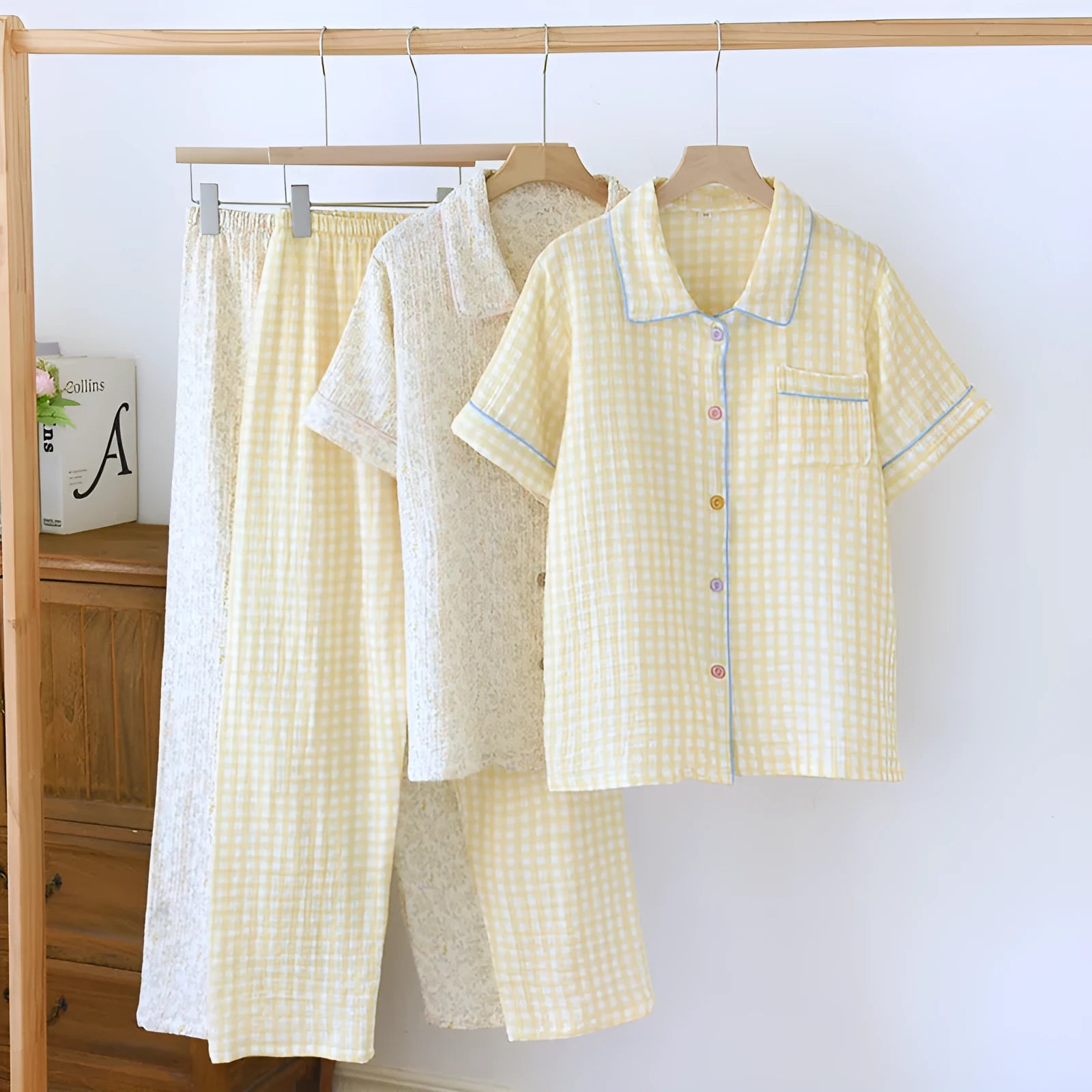 Young woman wearing a loose yellow plaid cotton gauze short-sleeved trousers suit.