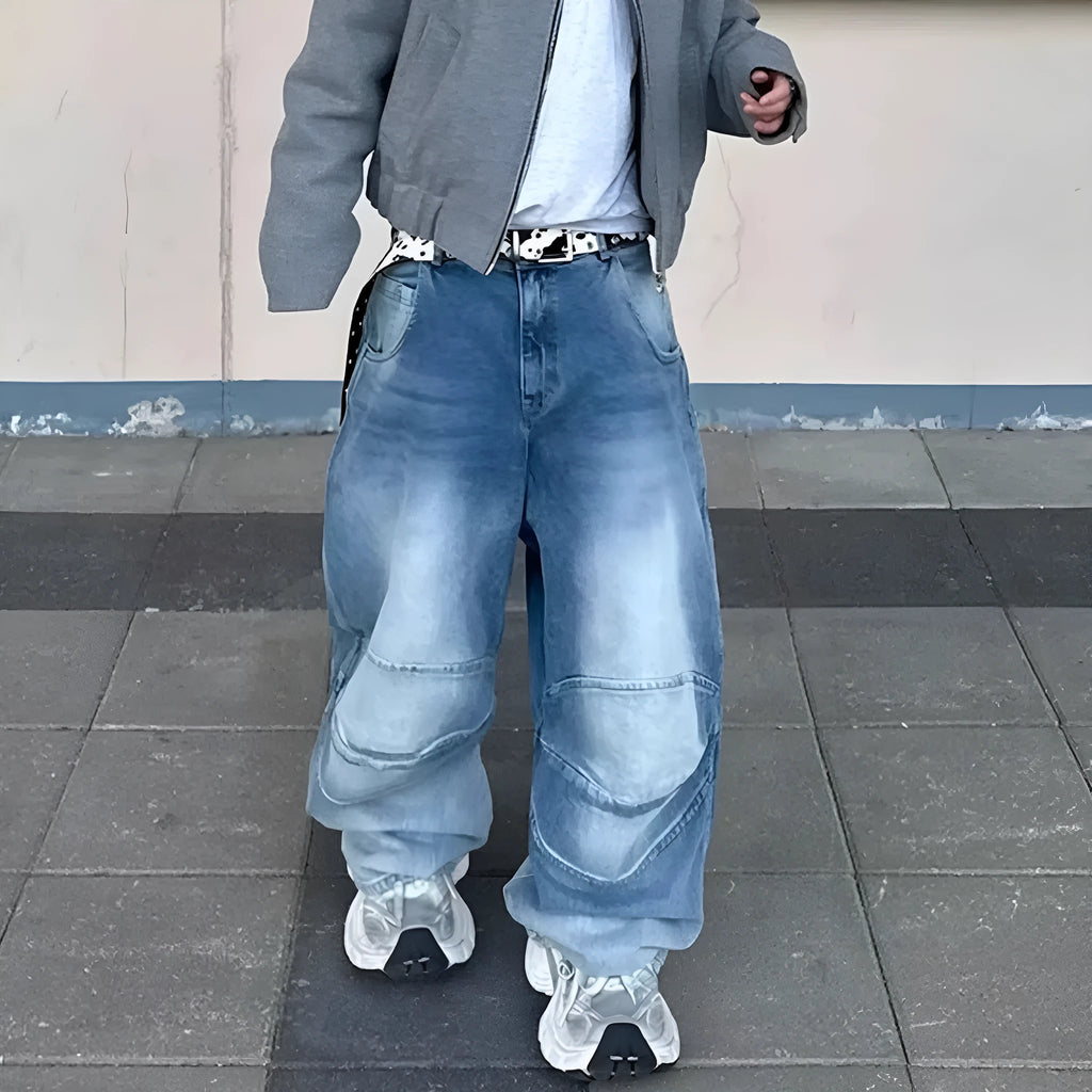 Men's light blue baggy jeans with front pleats and a straight-leg fit on a plain background.
