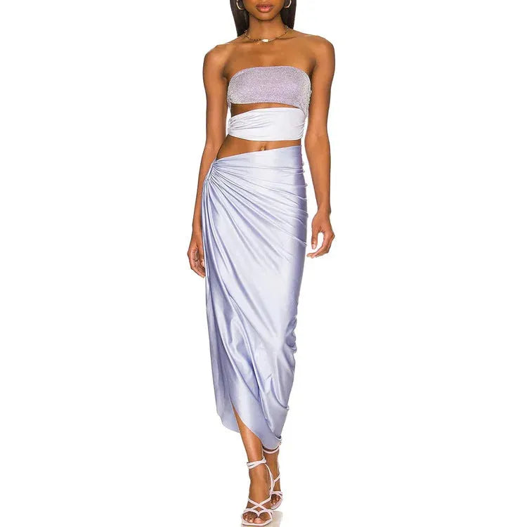 Purple one-piece swimsuit and matching wrap skirt set on a hanger.