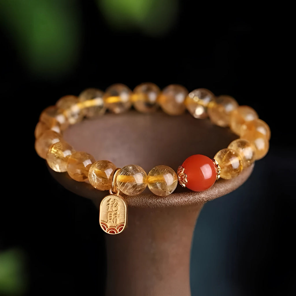 Red agate bracelet with gold ruby accents showing three bead size options on wrist