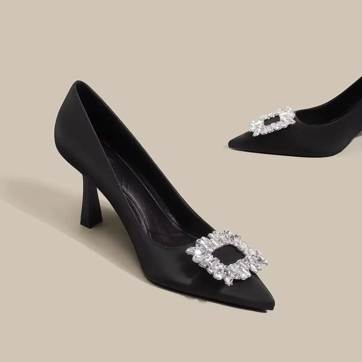 Women's creamy-white pointed toe stiletto pumps with a mid-height heel on a plain background.