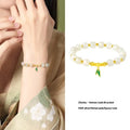 Sterling silver bracelet with gold Hetian jade beads and bamboo leaf charms