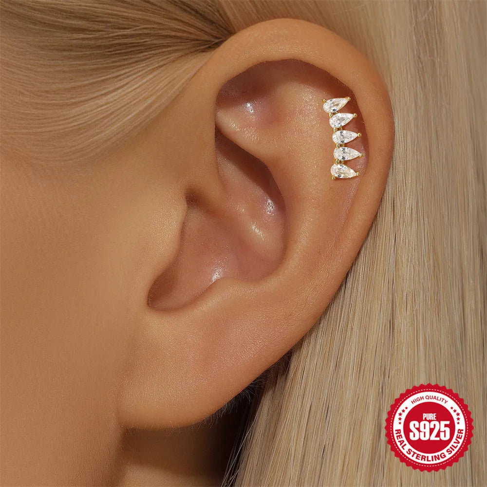 S925 sterling silver geometric moon and star earrings with embedded diamonds on a gold background.