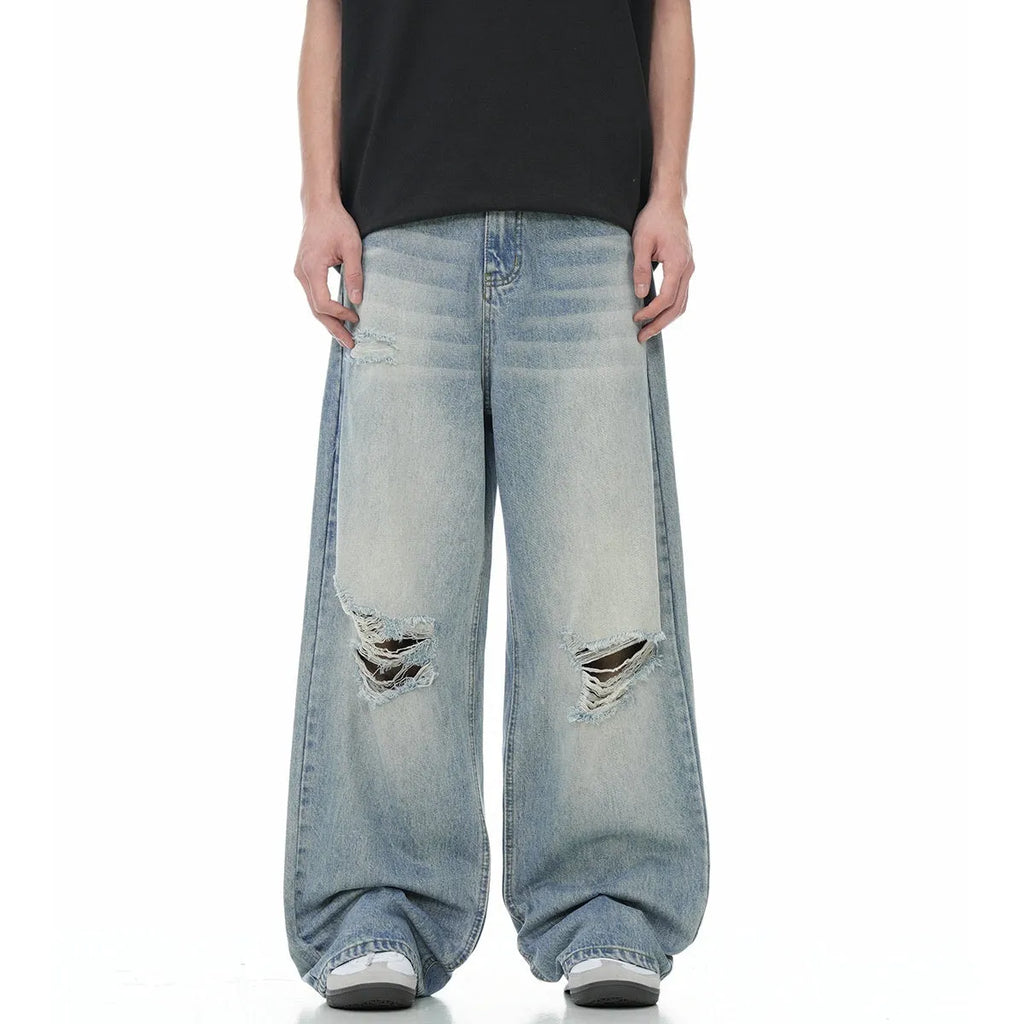 Blue retro-style men's straight-leg jeans with distressed detailing on a solid background