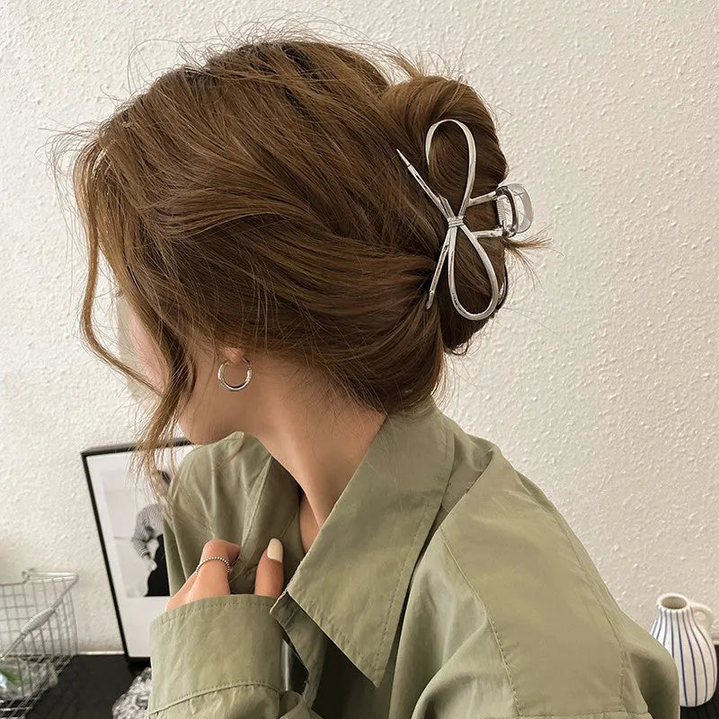 Women's bow hair barrette with back grip closure in gold or silver alloy