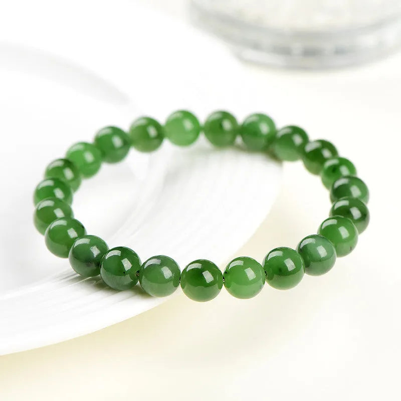 A single strand polished jasper bead bracelet in natural colours, showing different size options.