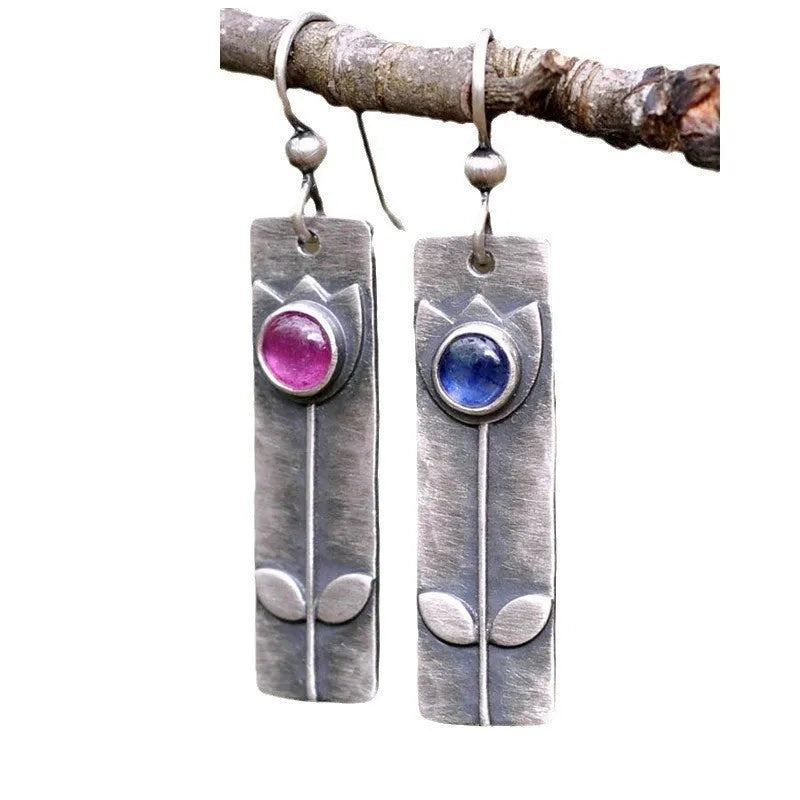 Antique finish geometric earrings with red sapphire stones and elliptical design elements
