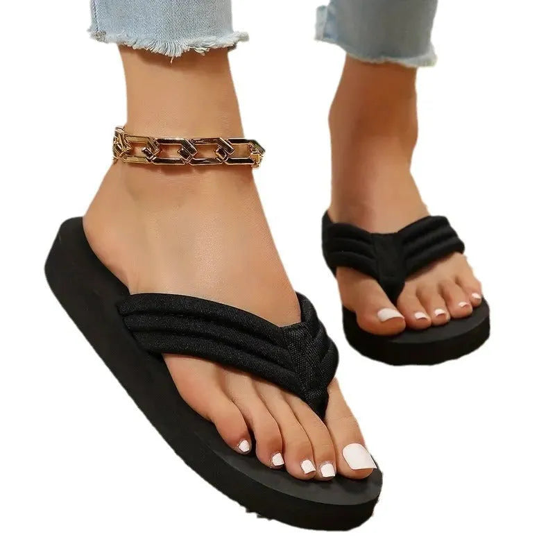 Black women's flat slippers with a cotton cloth upper, ribbon detail, and a non-slip EVA sole.