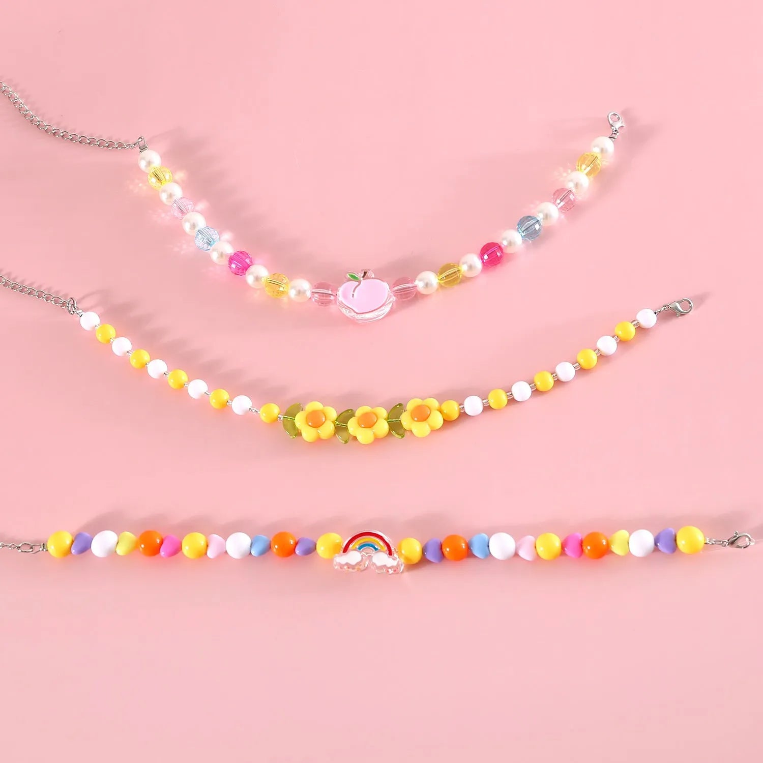 Colourful plastic bead pet necklace in peach, rainbow or small flower pattern with adjustable XS or S size options.