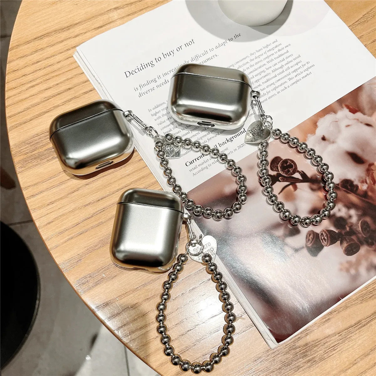 Matte plating TPU protective cover for Apple AirPods with an integrated carrying bracelet attached.