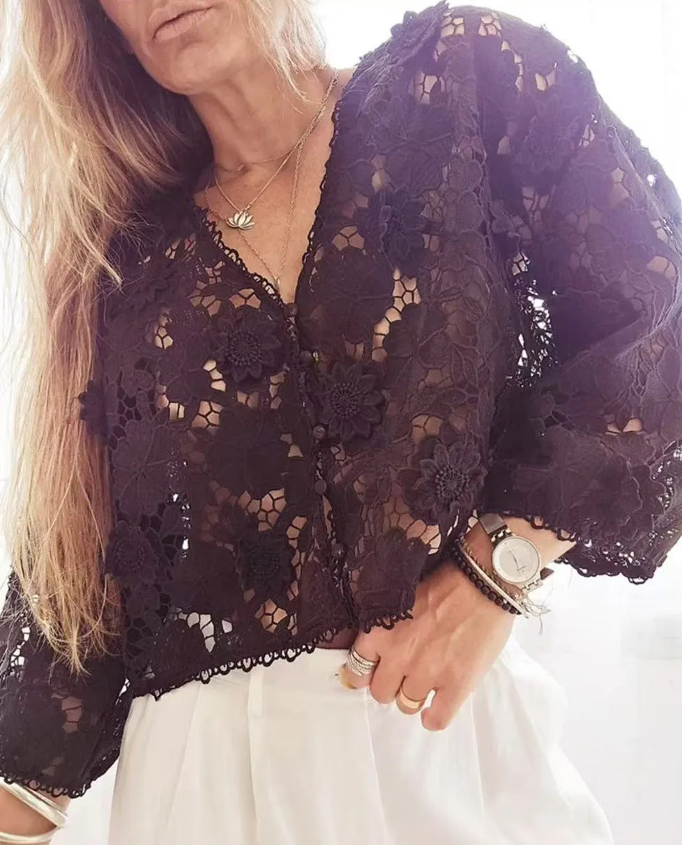 Black loose V-neck cardigan with white three-dimensional lace flowers on the front and hollow long sleeves.