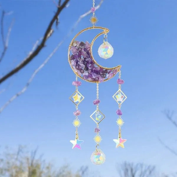 Car interior hanging pendant with large round crystal moon charm on a metal chain.