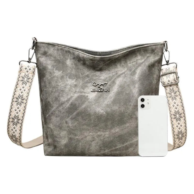 Soft grey PU crossbody bag with a large main compartment and adjustable shoulder strap