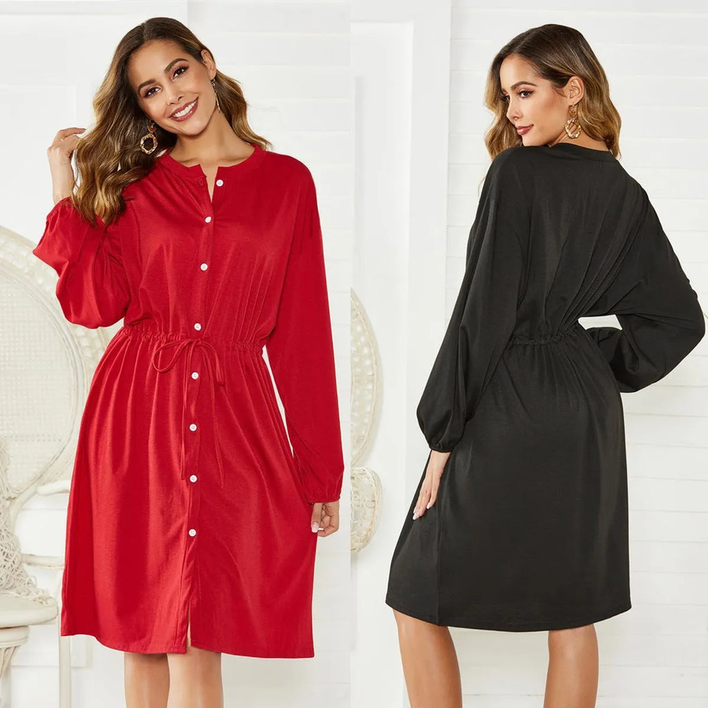 A women's loose black A-line dress with long sleeves, an elastic waist, and a cinched belt on a mannequin.