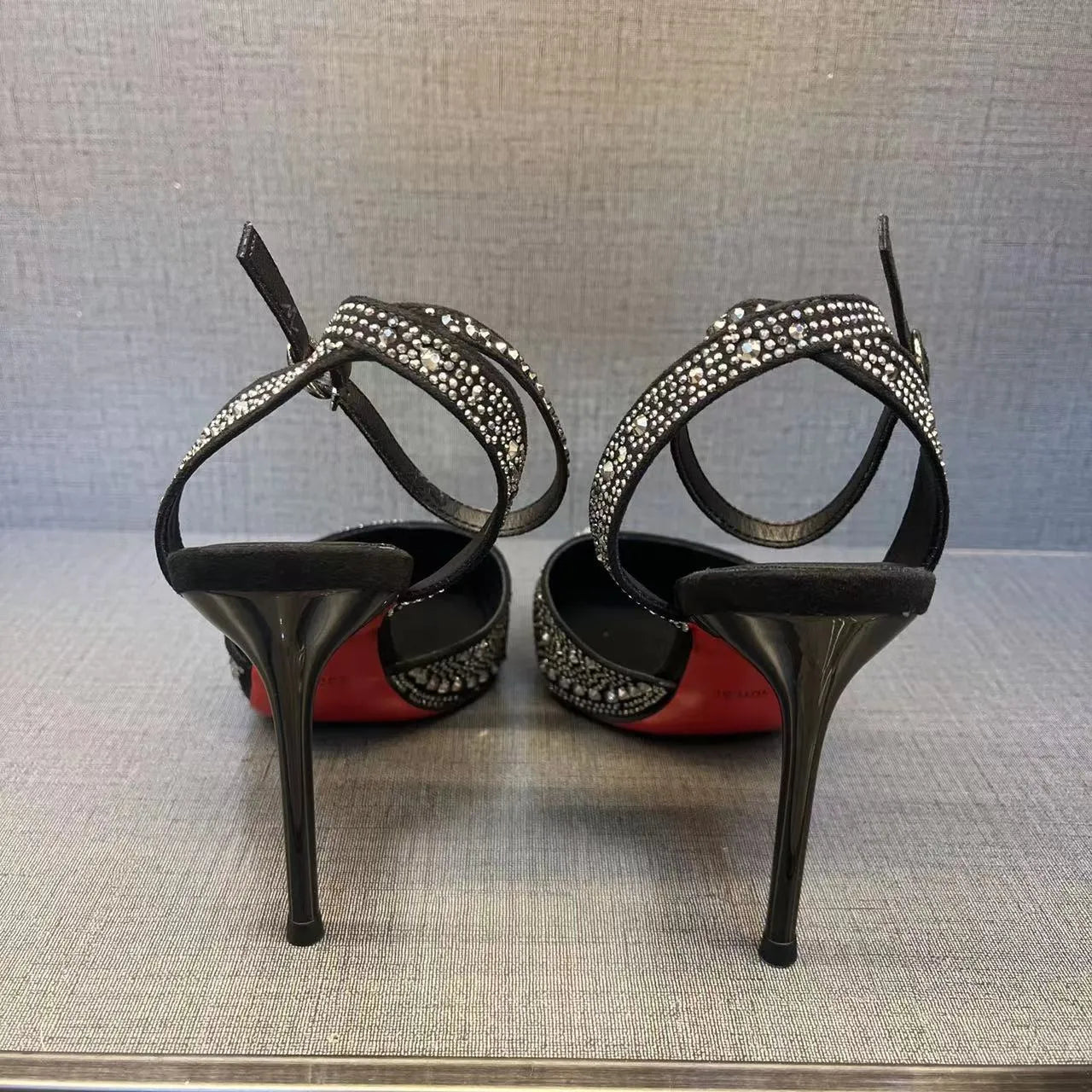 Women's black pointed-toe stiletto high heels with a hollow heel and red sole