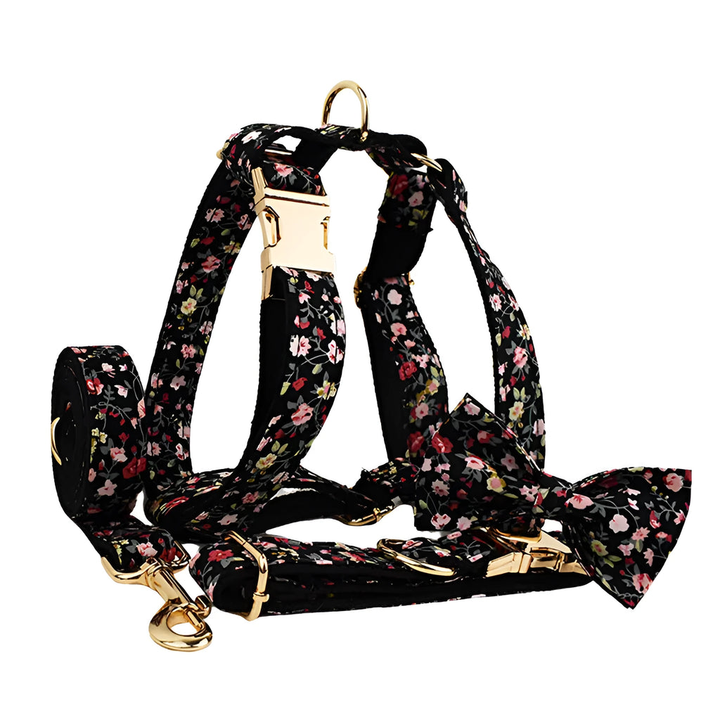 A cloth dog collar set with a removable bow, matching leash, and vest, featuring printed lettering.
