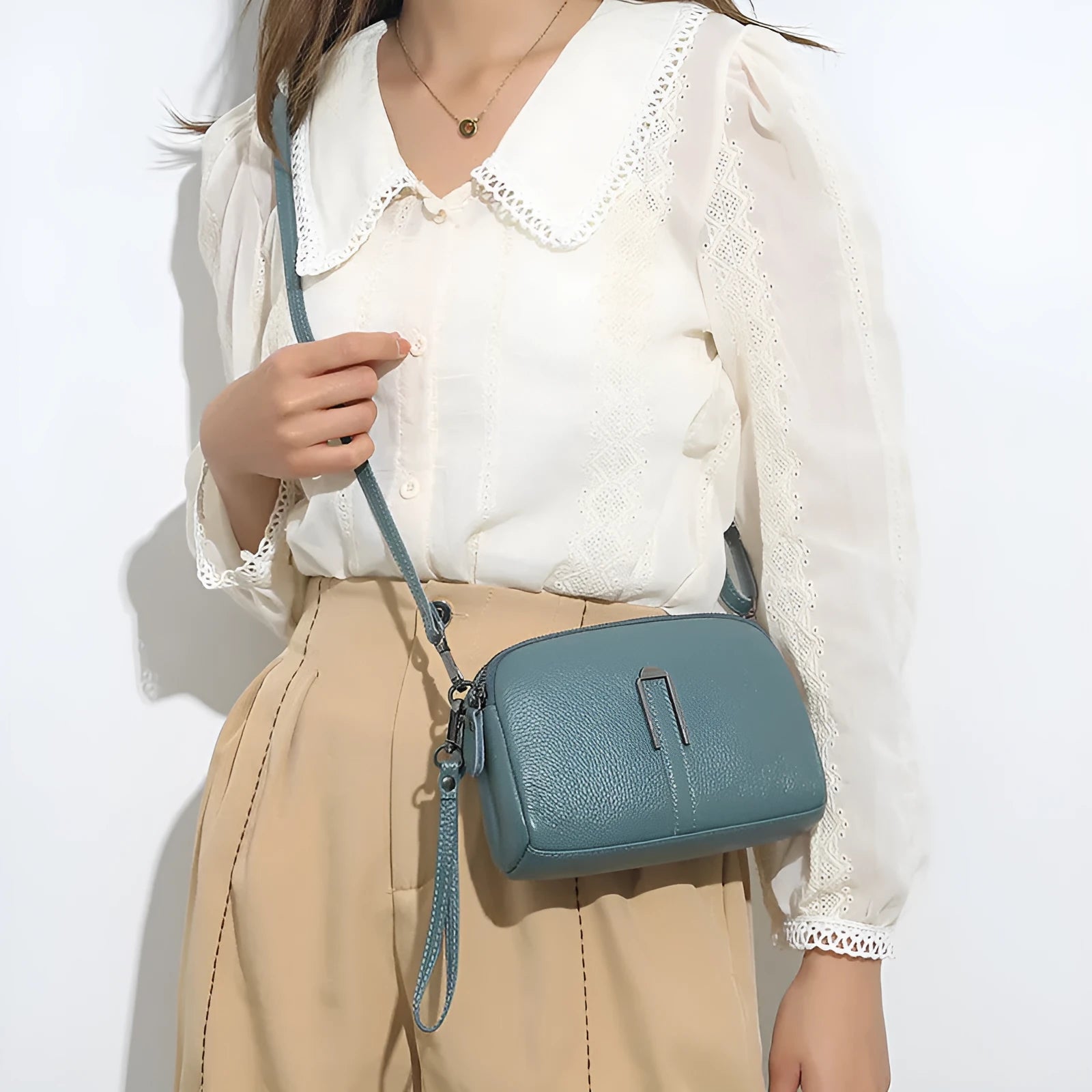Women's black genuine leather shoulder bag showing square shape and compact 19x13x6cm size