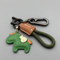 Handmade brown cowhide leather key ring pendant with a gold-toned zinc alloy pony belt buckle and green flanelle rope.