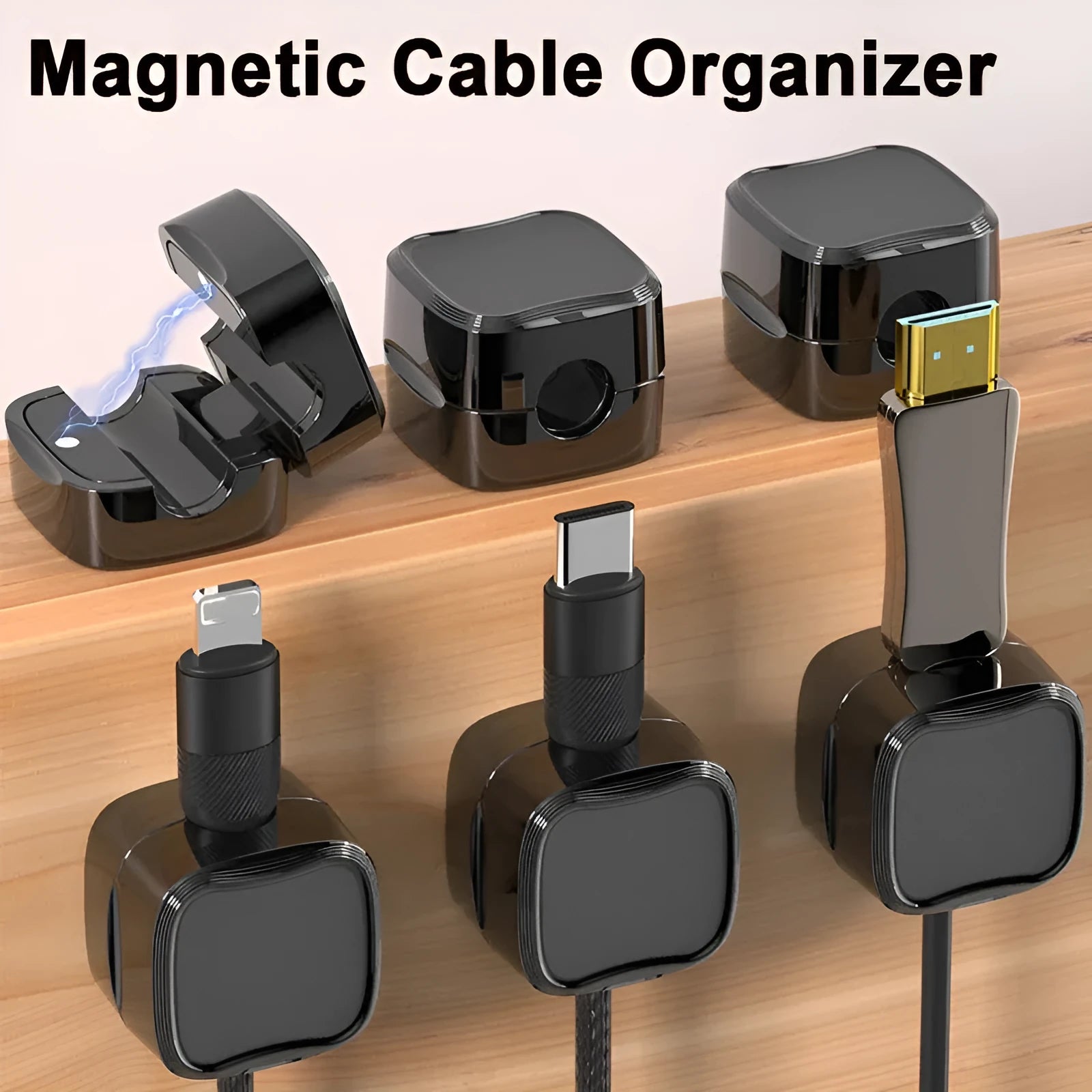 White and black magnetic cable clips with adhesive backing holding a USB cable against a wooden desk edge.