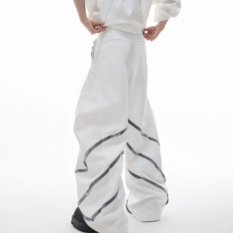 Men's black trousers with three-dimensional cut, metal striped rivets, and pleated detailing