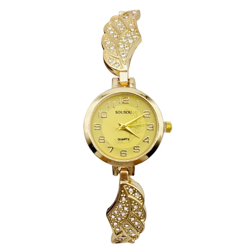 Stainless steel women's wristwatch with a round dial and vachette clasp, showing a gold-coloured surface.