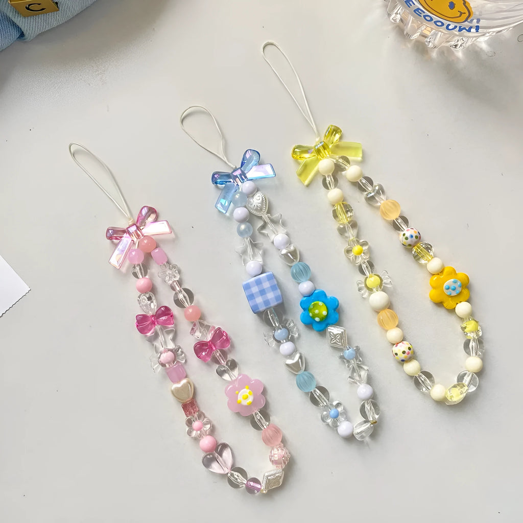 Blue, pink, and yellow beaded flower phone lanyard on a white background.