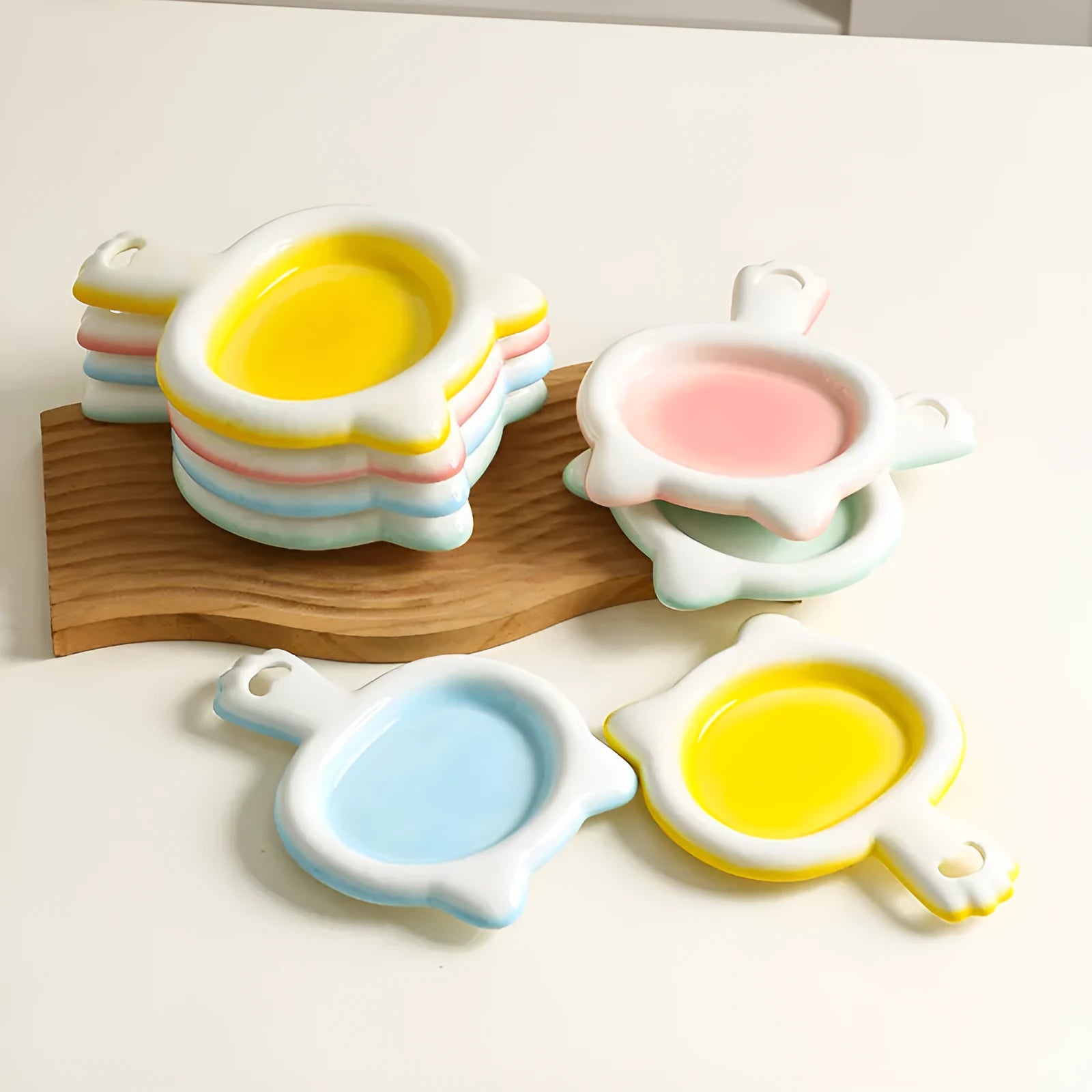 Ceramic cat bowl in blue, green, pink, or yellow colour options, shown in large and small sizes with shallow mouth design.