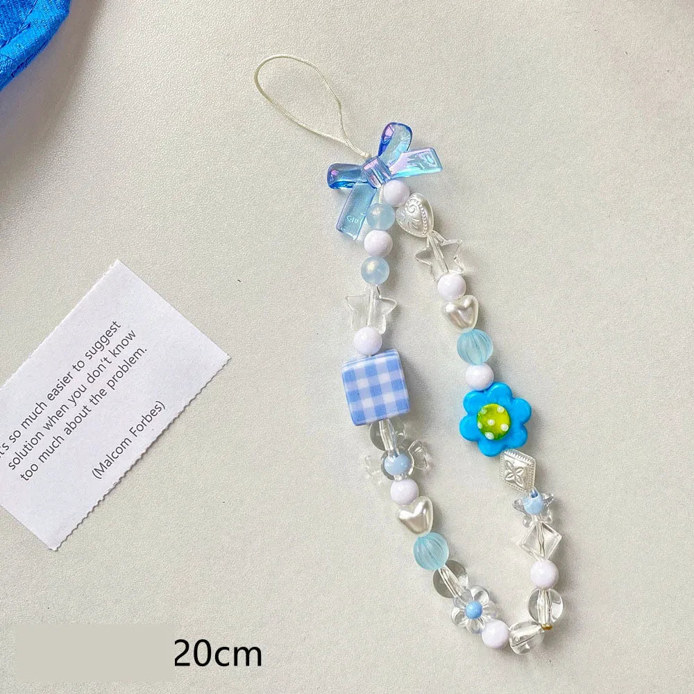Blue, pink, and yellow beaded flower phone lanyard on a white background.