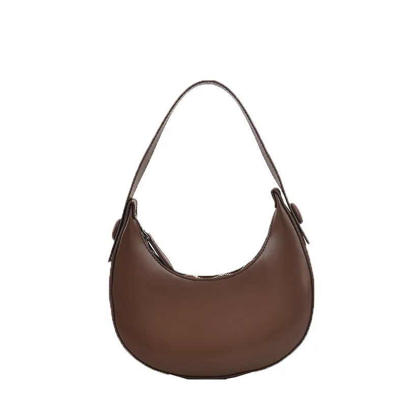 Women's retro-style PU dumpling shoulder bag in black, showing front zipper compartment.