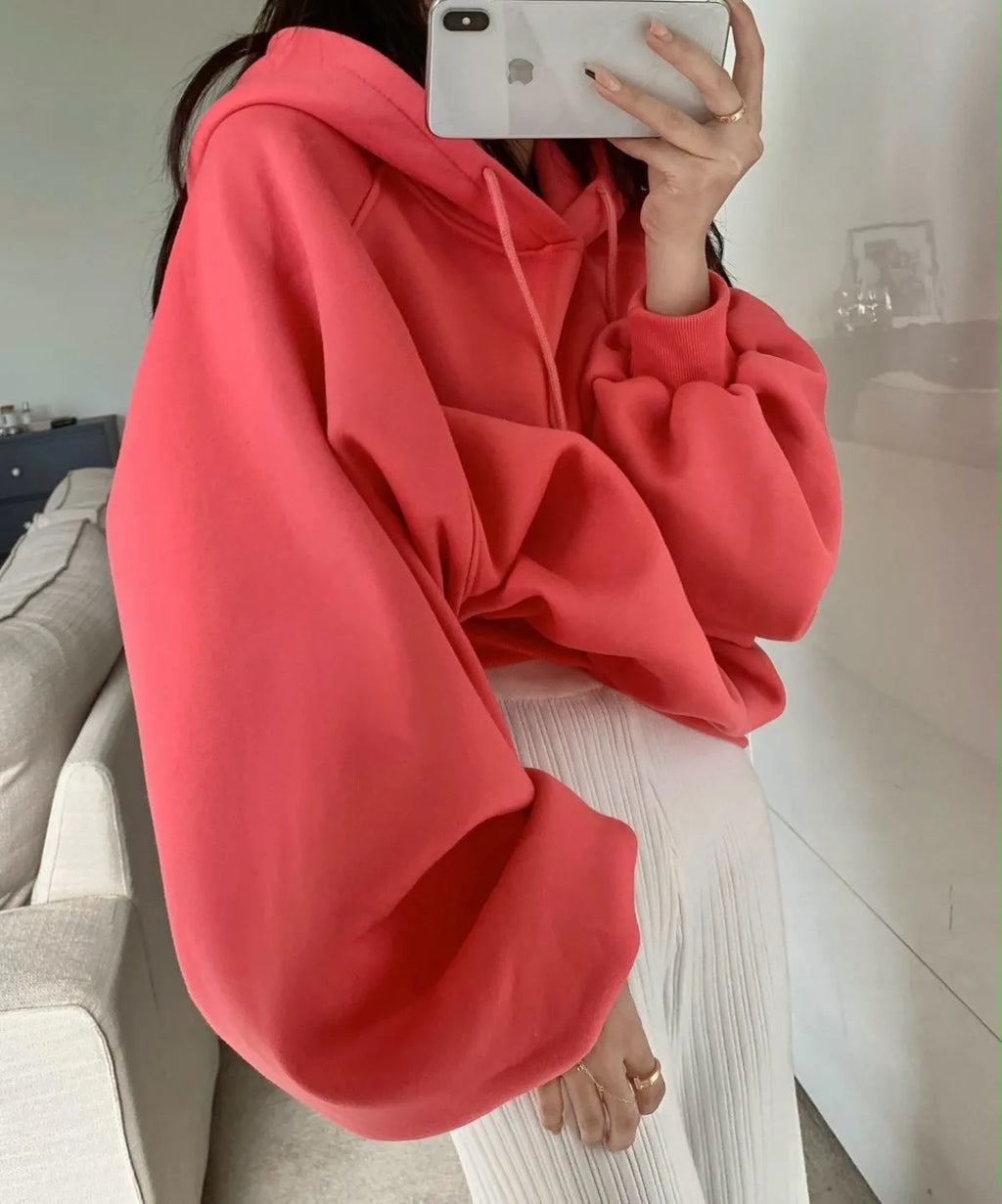 Women's loose watermelon red mulberry silk hooded pullover sweater on a hanger.