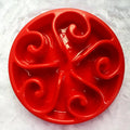 A coloured slow feeder dog bowl with a maze pattern design and a wide non-slip base.