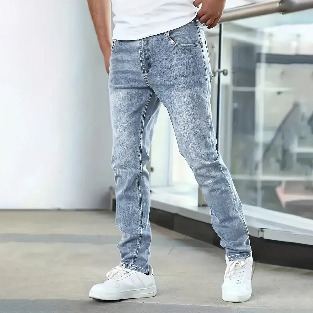 Men's slim-fit stretch jeans in dark blue on a neutral background.