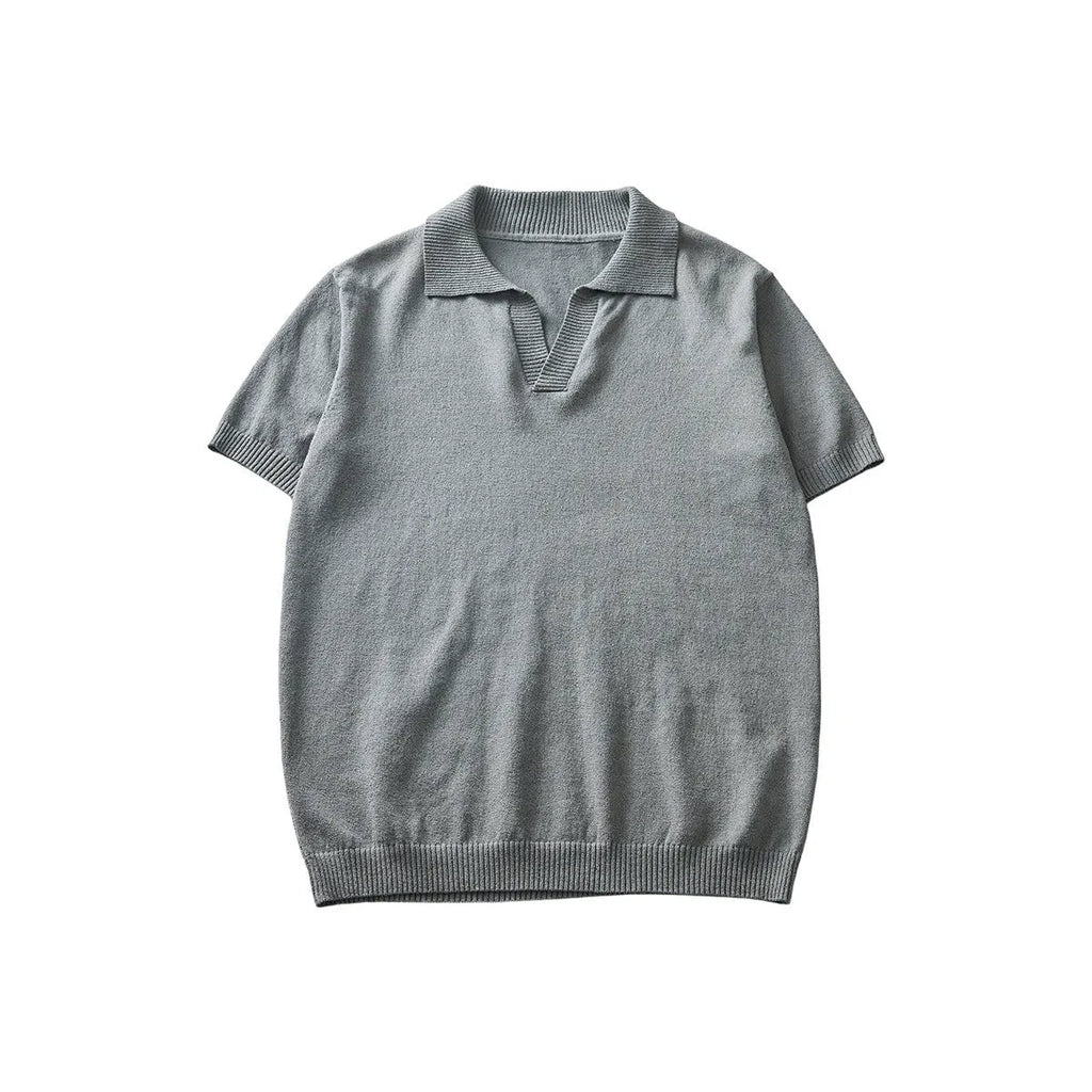 Men's solid colour knitted polo t-shirt on a hanger, showing short sleeves and a casual collar.