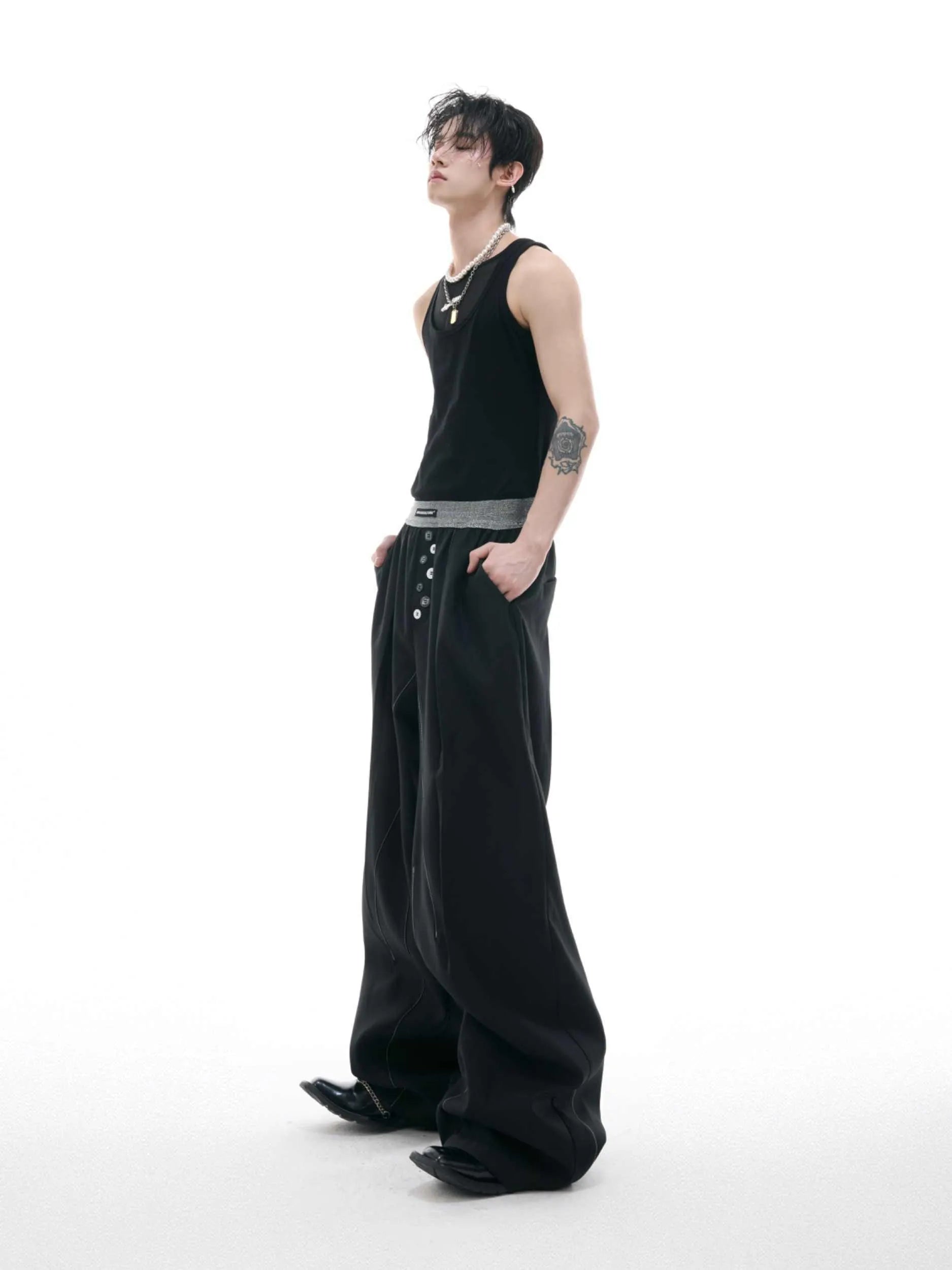Black high-waisted straight-leg casual trousers featuring a button-open line design detail on the leg.