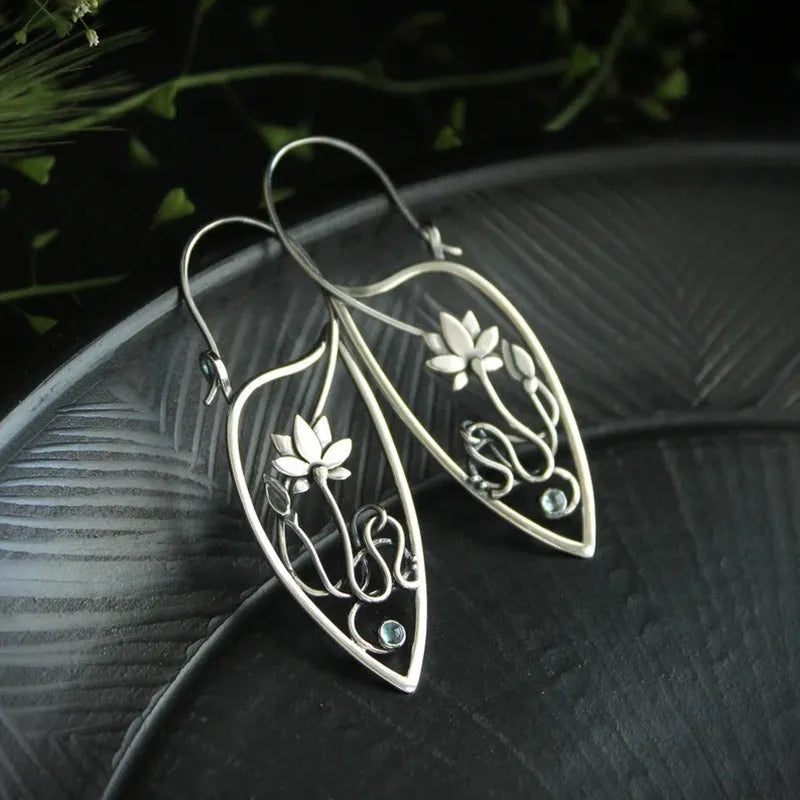 Silver lotus flower vine earrings with geometric rhinestone accents and retro styling