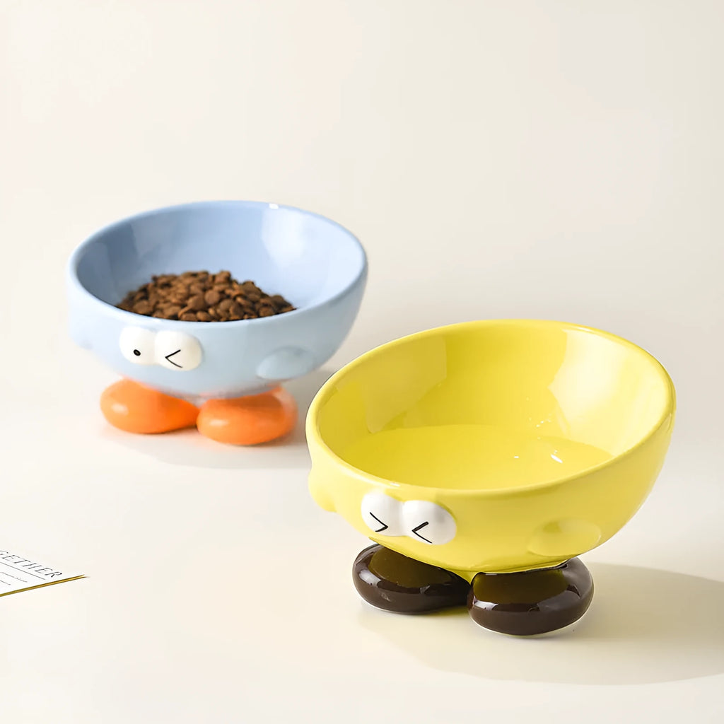 Blue oblique tall ceramic pet bowl with a cute expression design for cats and dogs.
