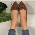 Women's knitted loafers with bow decoration in various colours showing flat rubber soles