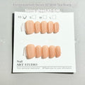 Set of velvet frosted Cat's Eye press-on nails showing Aurora armour design in short ladder sizes on a hand.