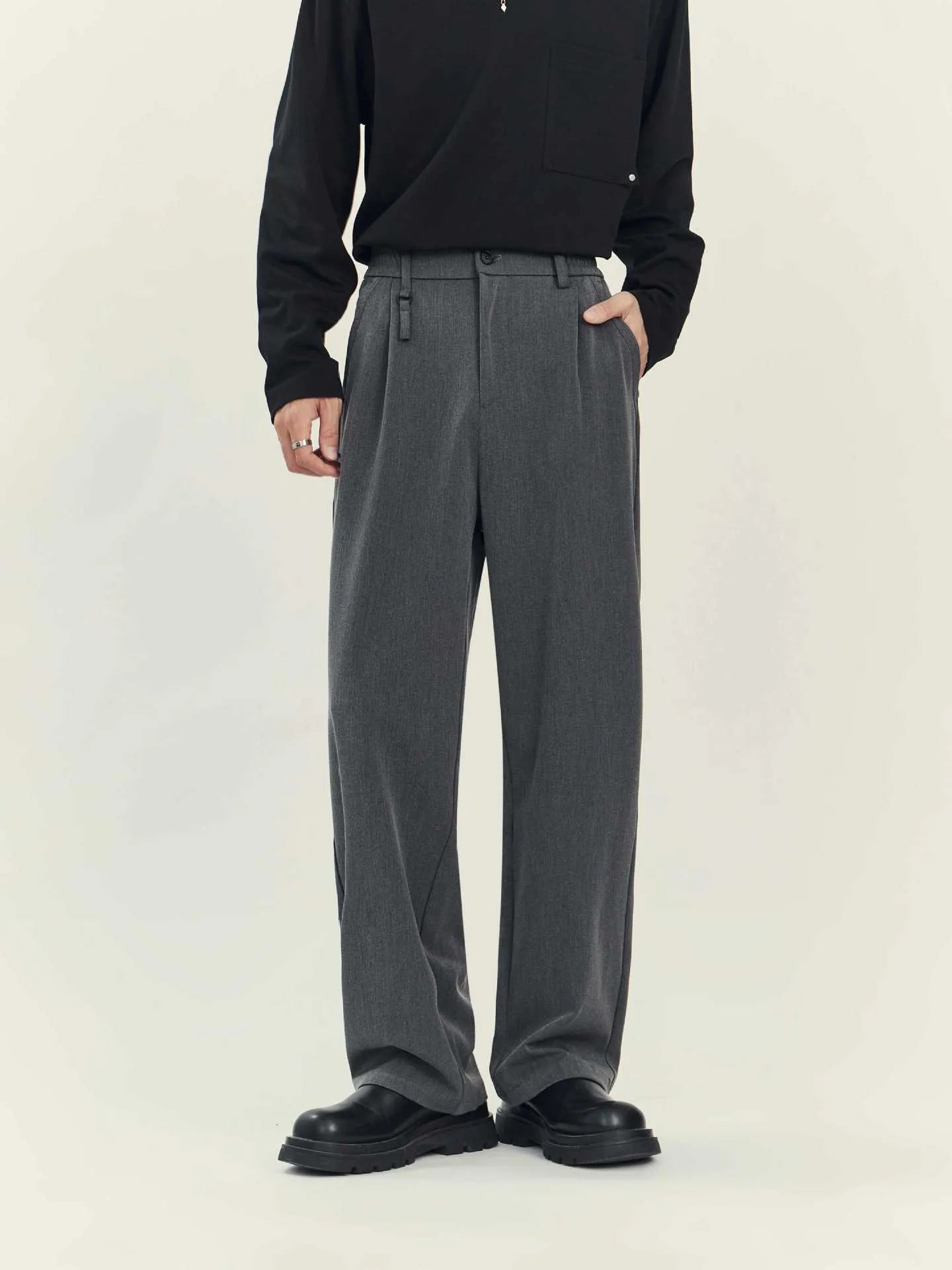 Man's black loose straight-leg business casual trousers made from a draping polyester blend fabric.