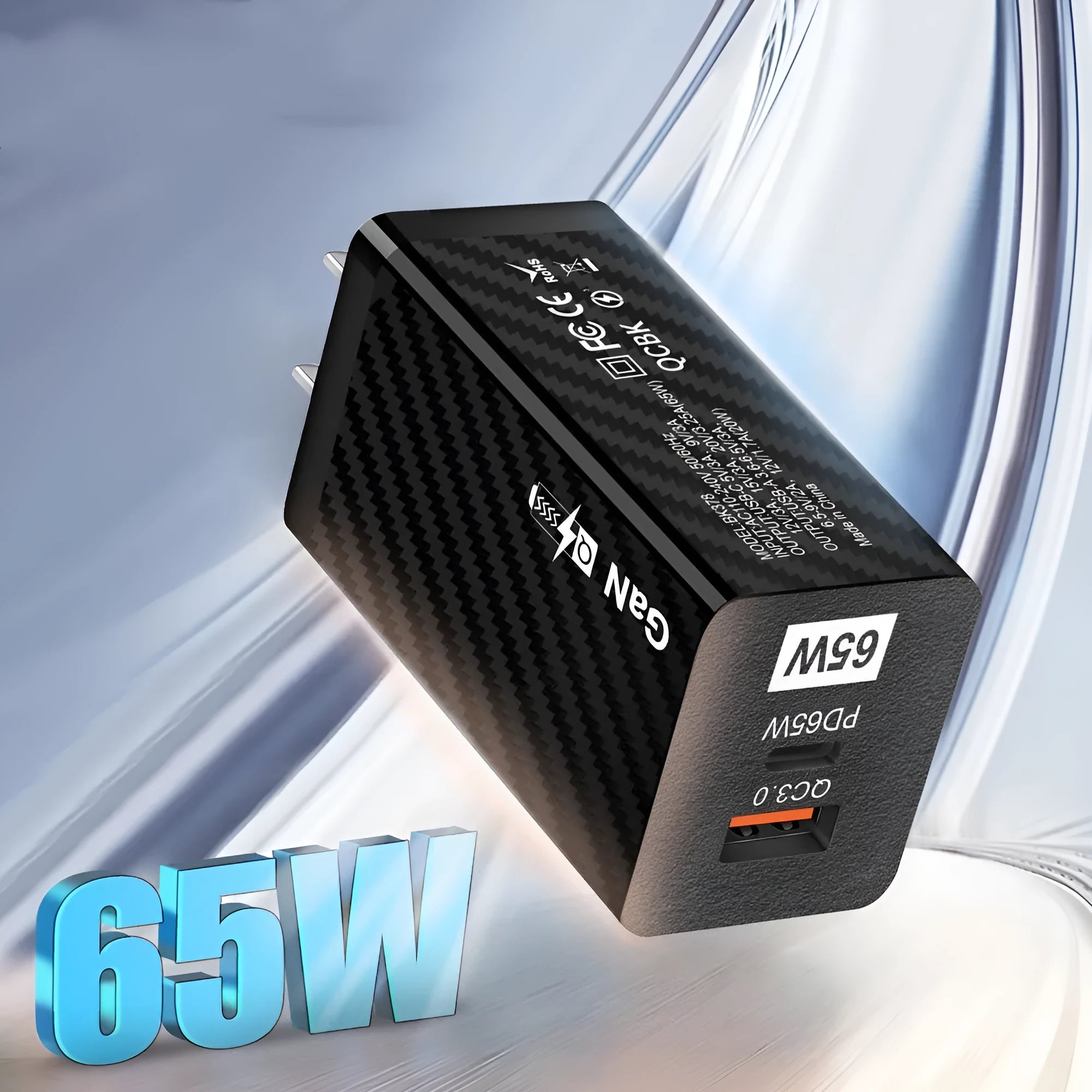 Compact black 65W GaN USB-C laptop charger with interchangeable EU UK US plug heads shown alongside scale