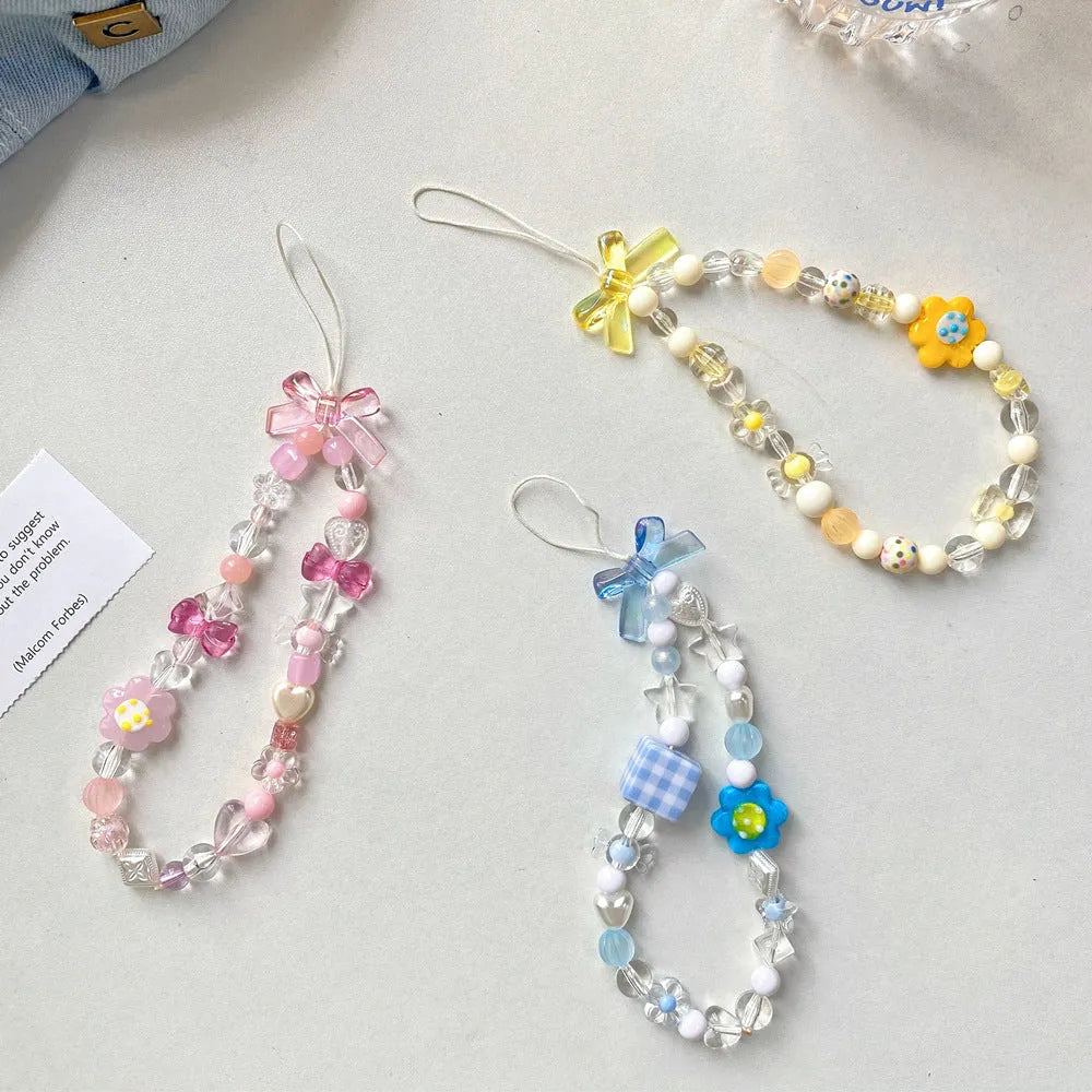 Blue, pink, and yellow beaded flower phone lanyard on a white background.