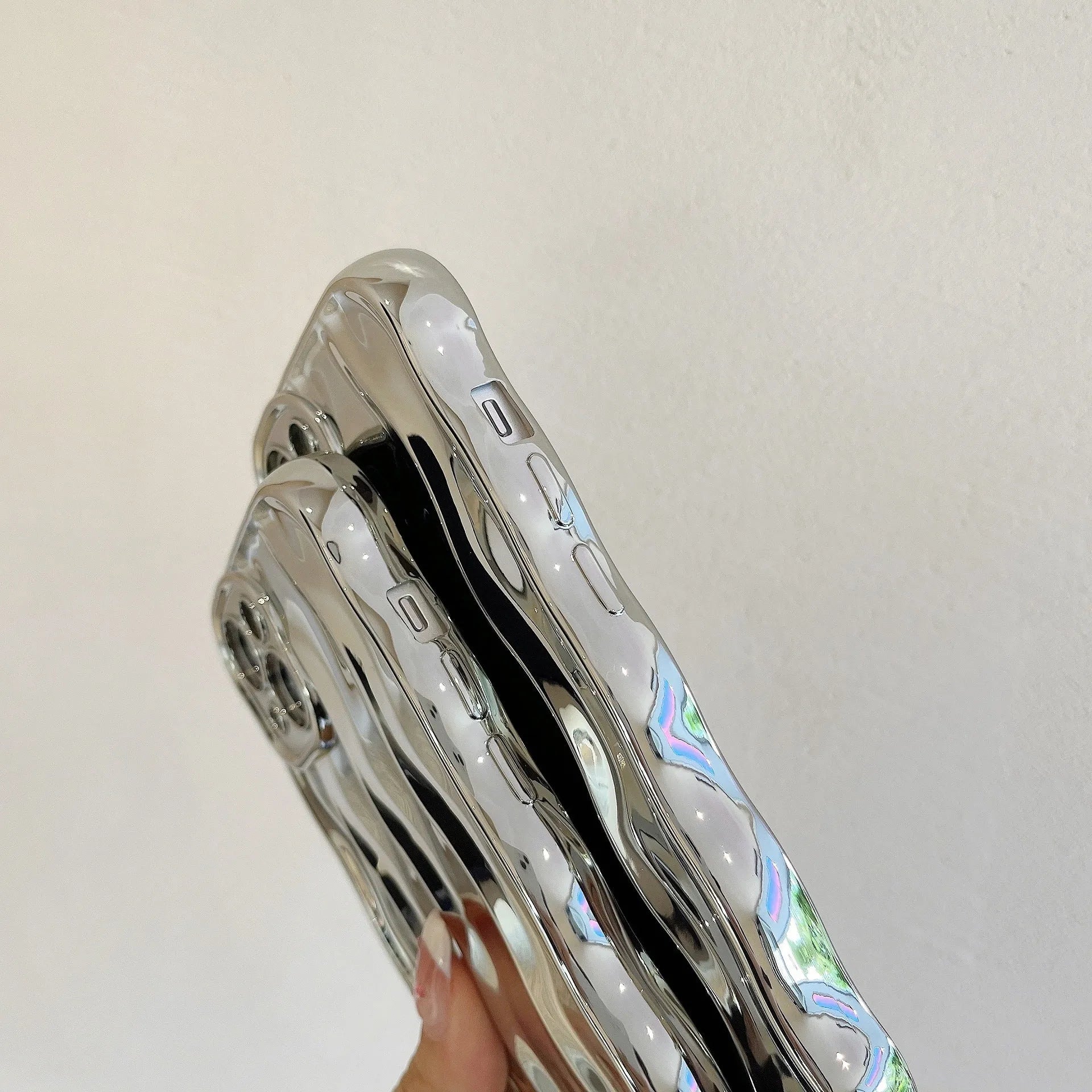 iPhone 17 phone case with raised wave stripe pattern in electroplated silver colour.