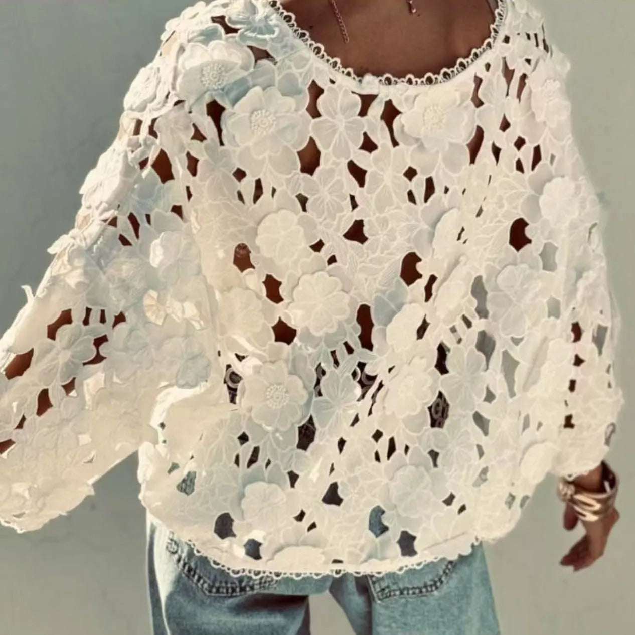 Black loose V-neck cardigan with white three-dimensional lace flowers on the front and hollow long sleeves.
