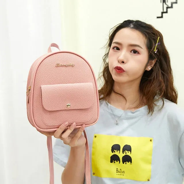 Black PU leather small women's backpack with zipper, shown as a shoulder bag.