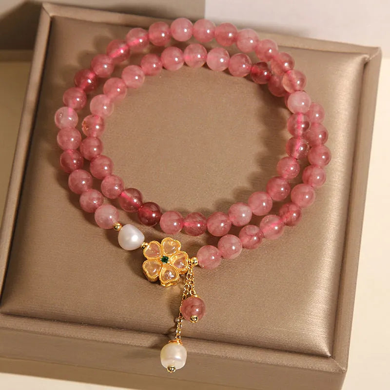 Women's double ring bracelet with strawberry quartz four-leaf clover charm and alloy inlay detailing