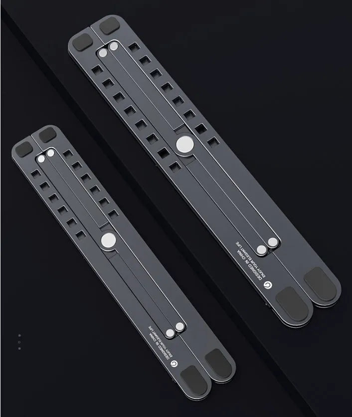 Foldable aluminium laptop stand in silver, shown supporting a laptop at an angle.