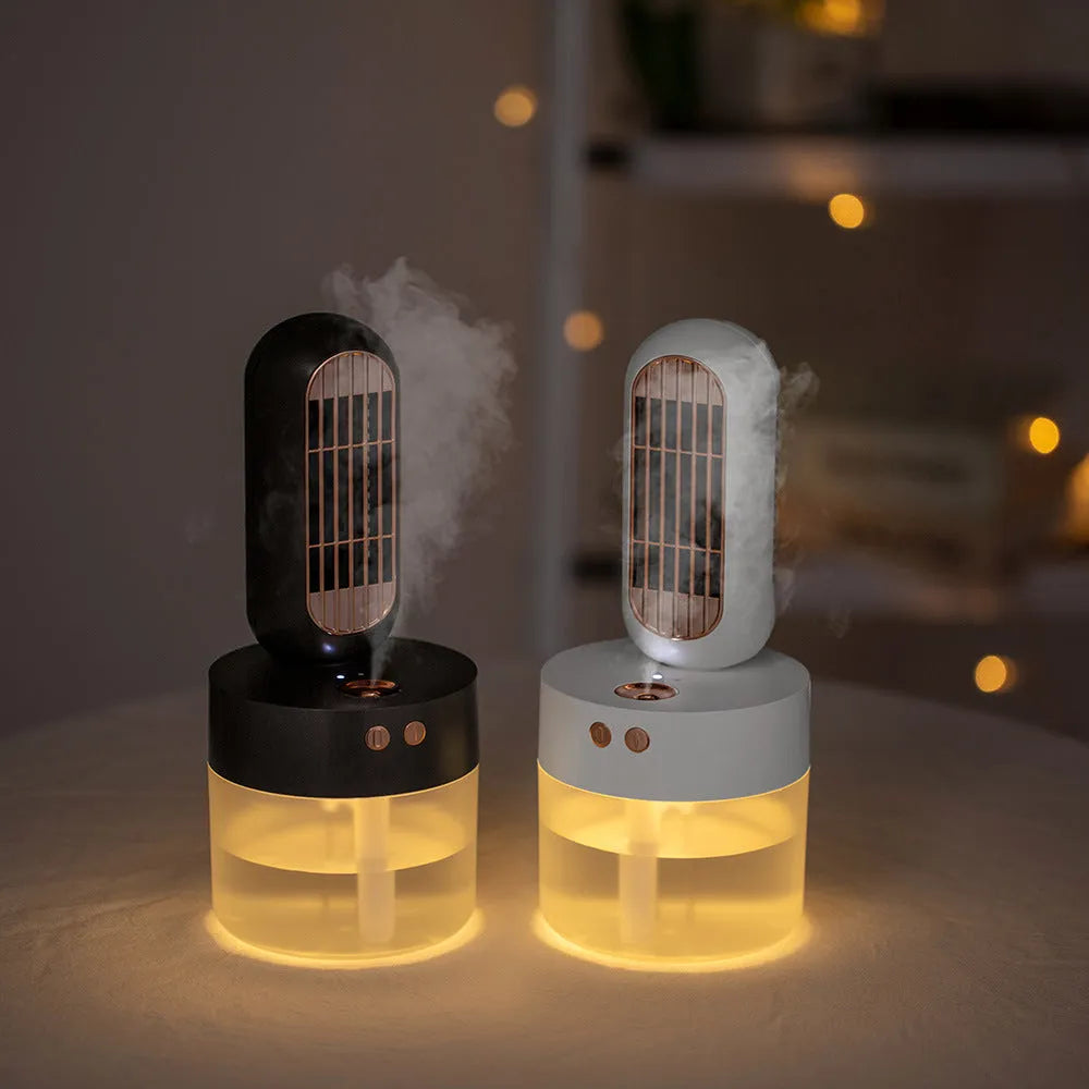 Small black and white humidifier fan with shaking head on a desktop