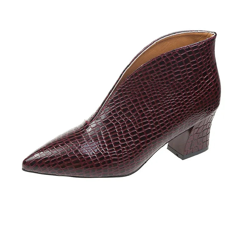 Women's black V-cut Martin boots with embossed PU upper and chunky heel on a neutral background.